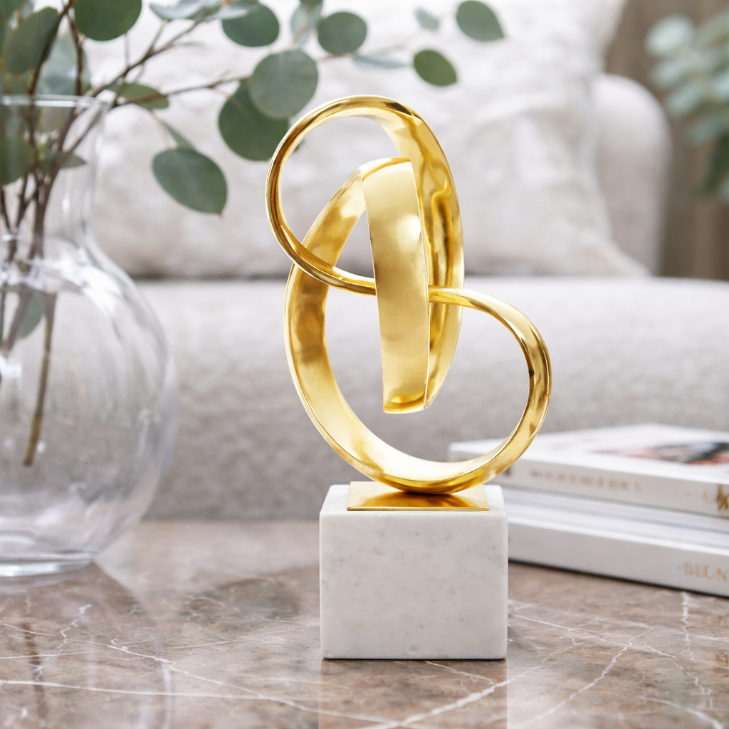 Gold knot sculpture on a pale base